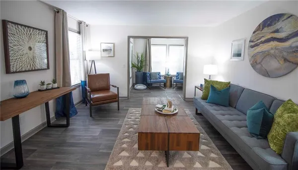 a living room with furniture and wooden floor