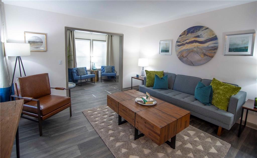 3900 Paces Walk Southeast, Unit 2629E Atlanta, GA 30339 - Photo 7 of 27 a living room with furniture a rug and a window