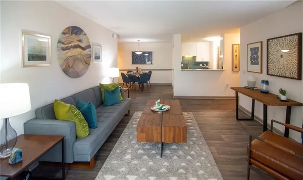 a living room with furniture and wooden floor
