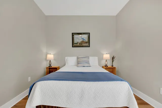 an aerial view of a house with yard and trees in the background