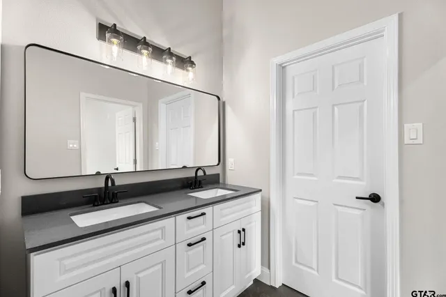 a bathroom with a sink and a mirror