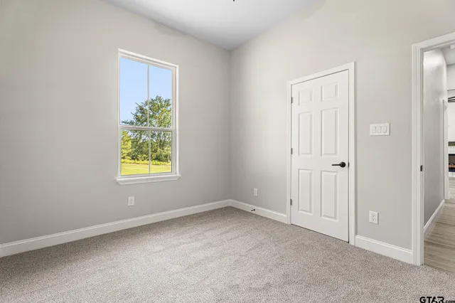 an empty room with windows and entrance