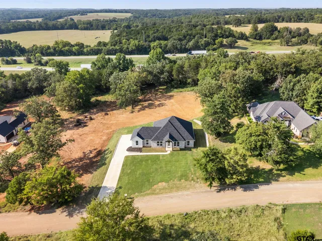 an aerial view of a house with a yard