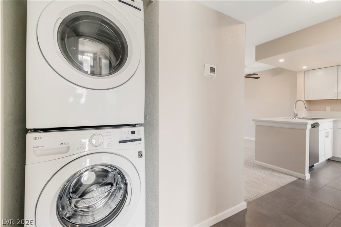 8070 West Russell Road, Unit 2006 Las Vegas, NV 89113 - Photo 7 of 24 A well-appointed laundry area with modern stacked appliances seamlessly integrates into the home's functional design.