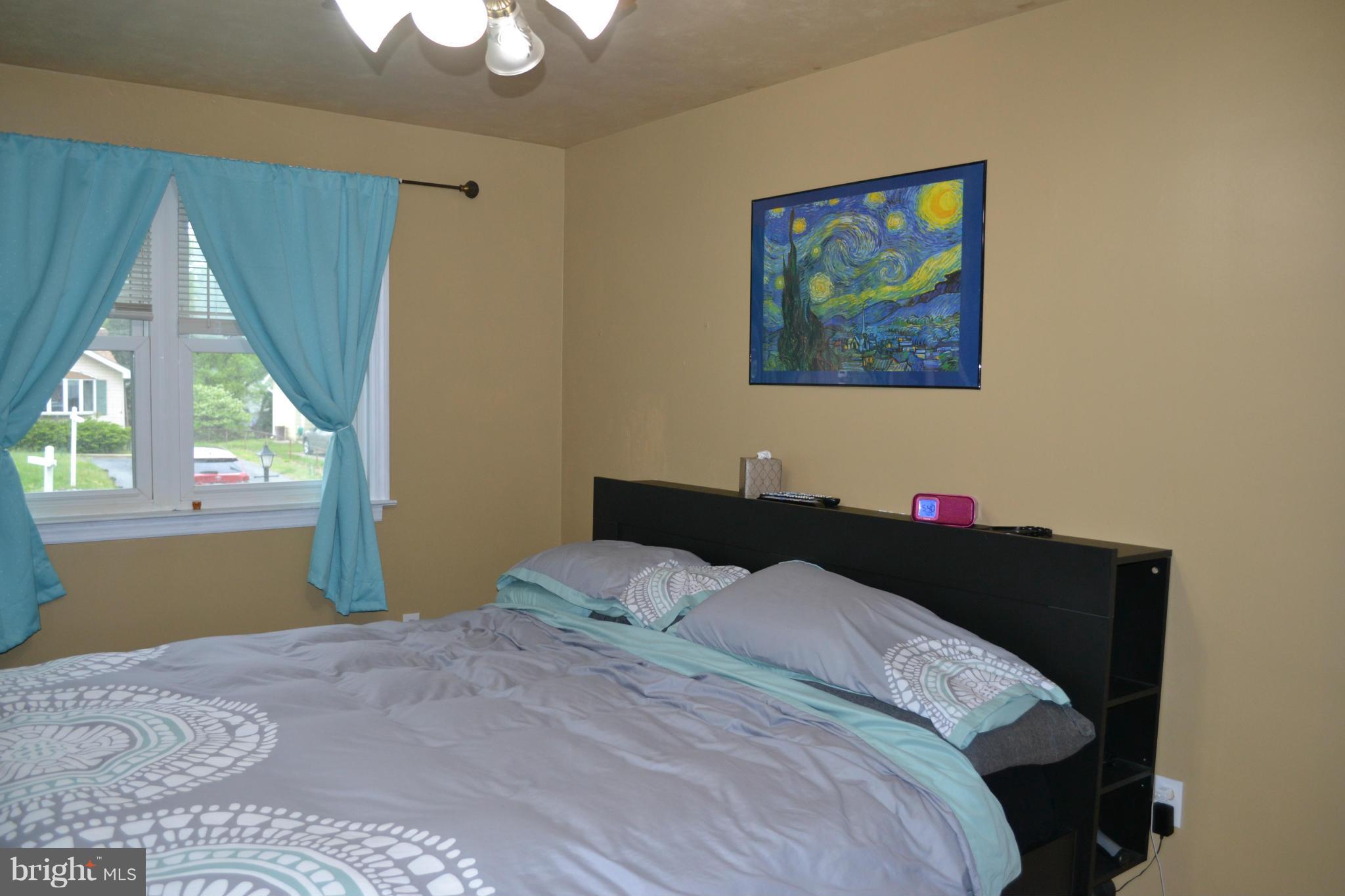 1211 Meadow View Road Pasadena, MD 21122 - Photo 18 of 20 a bedroom with a bed and a window