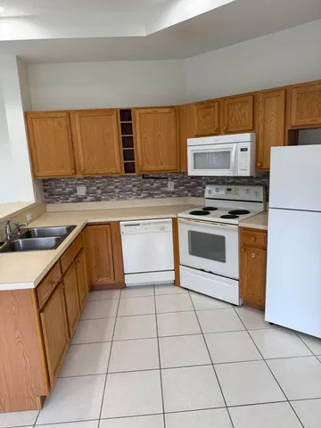 a kitchen with a stove a sink and a refrigerator