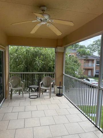 a view of two chairs in the patio