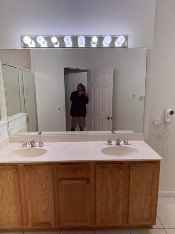 a bathroom with a sink vanity and a mirror
