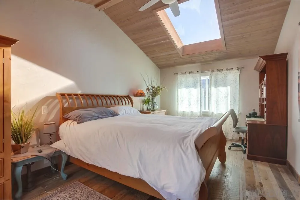 342 Cole Ranch Road Encinitas, CA 92024 - Photo 16 of 34 a bedroom with a bed and wooden floor