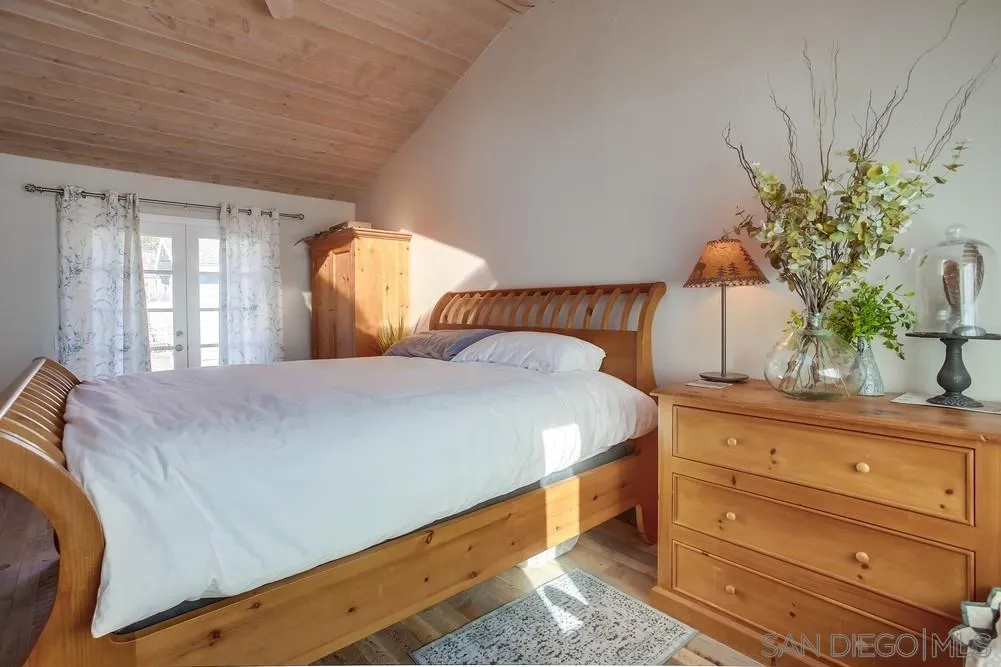 342 Cole Ranch Road Encinitas, CA 92024 - Photo 17 of 34 a bedroom with a bed and a potted plant