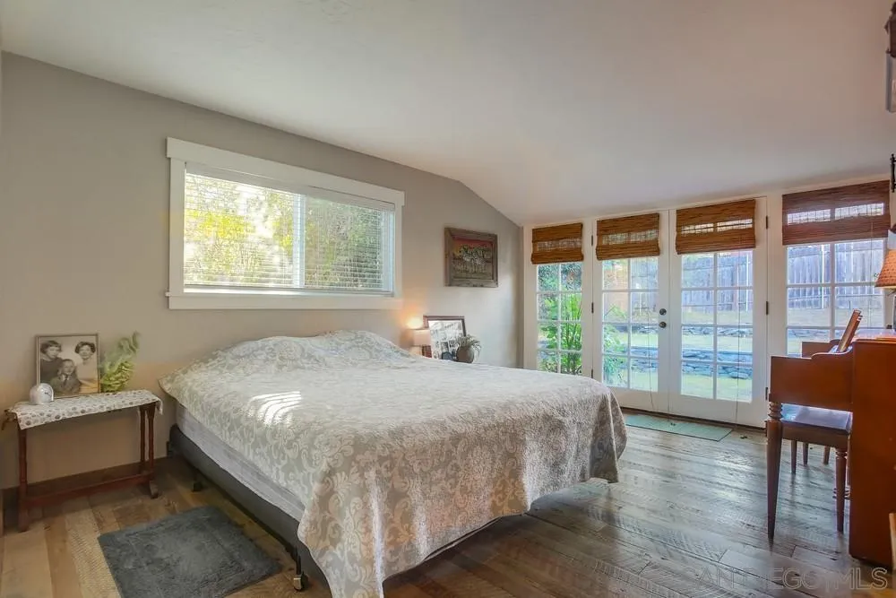 342 Cole Ranch Road Encinitas, CA 92024 - Photo 20 of 34 a bedroom with a bed and wooden floor