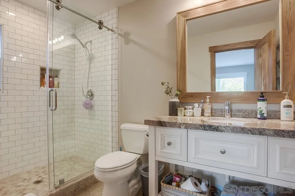 342 Cole Ranch Road Encinitas, CA 92024 - Photo 23 of 34 a bathroom with a granite countertop toilet sink and shower