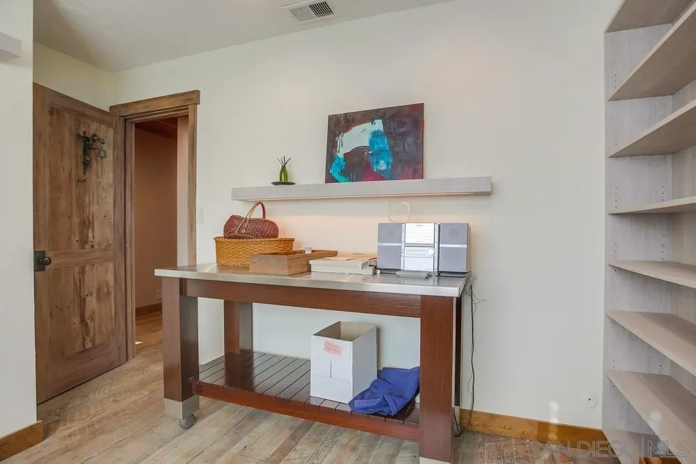 342 Cole Ranch Road Encinitas, CA 92024 - Photo 27 of 34 a room with a table and cabinets