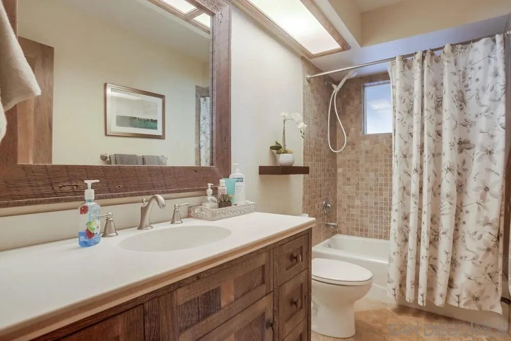 342 Cole Ranch Road Encinitas, CA 92024 - Photo 31 of 34 a bathroom with a sink a toilet a mirror and shower