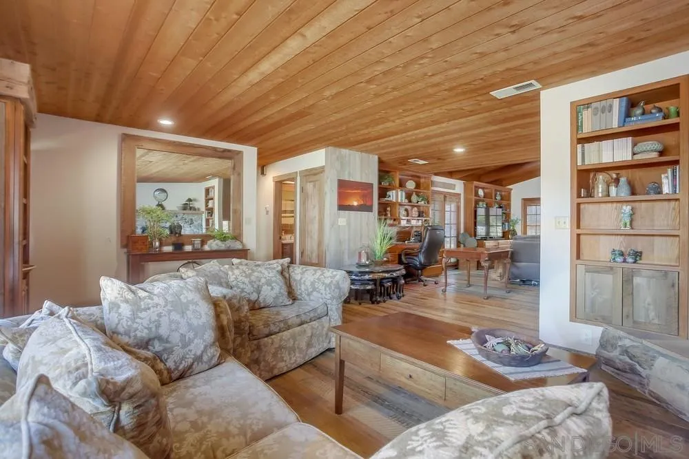 342 Cole Ranch Road Encinitas, CA 92024 - Photo 5 of 34 a living room with furniture and a book shelf
