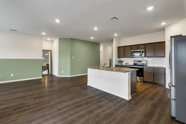 a kitchen with a refrigerator and a microwave