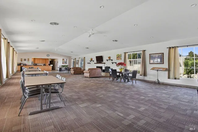 a living room with furniture a table and chairs