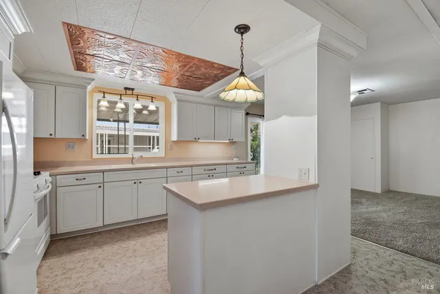 a kitchen with stainless steel appliances granite countertop a sink a stove and a wooden floors