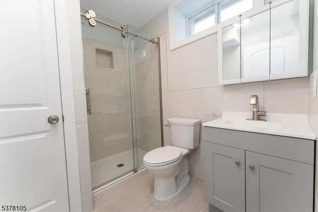 a bathroom with a toilet a sink and shower