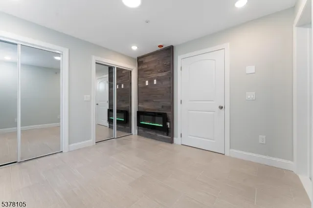 an empty room with closet and a bathroom