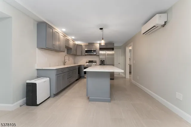 a kitchen with stainless steel appliances a sink stove and cabinets