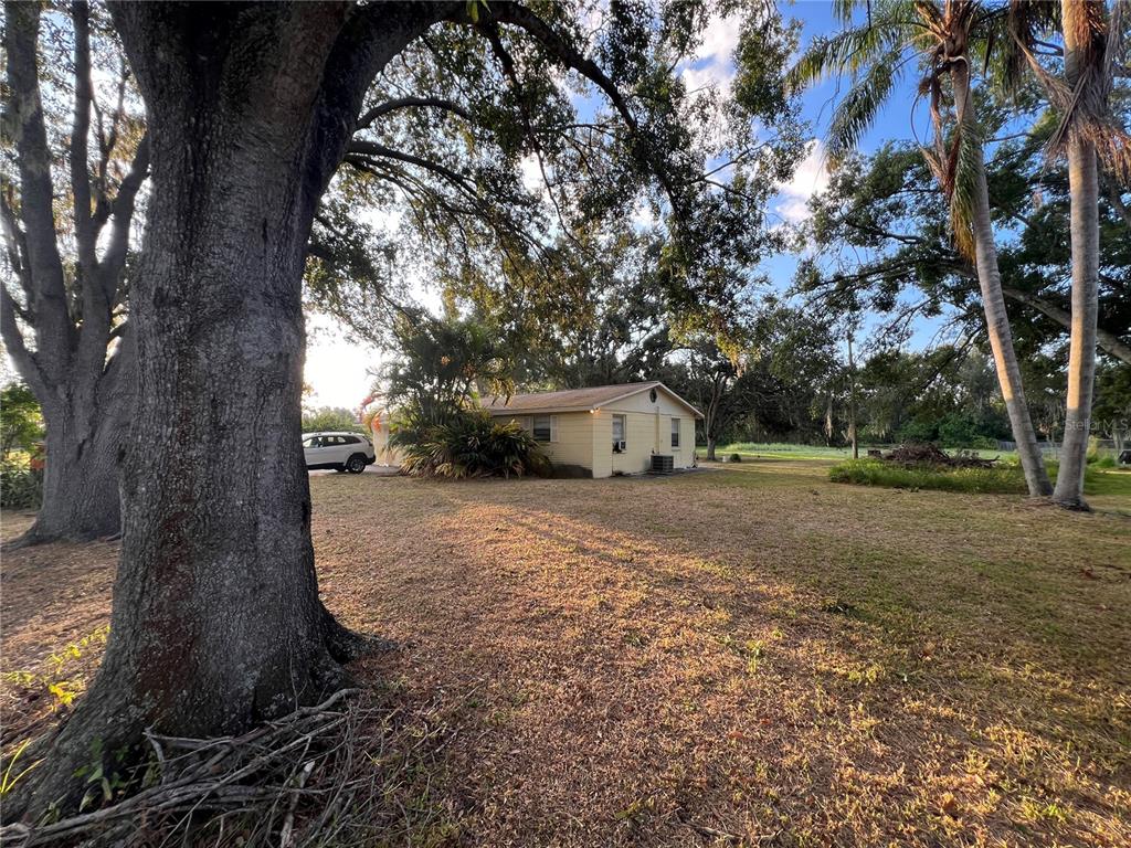 9013 Symmes Road Gibsonton, FL 33534 - Photo 7 of 9 a big house with trees in front of it