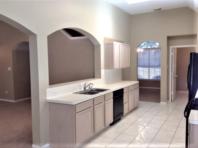 a spacious bathroom with a sink and a mirror