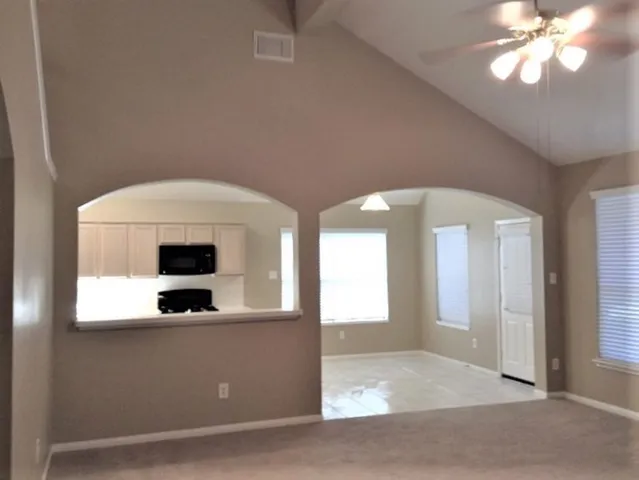 a view of a kitchen with a sink cabinet and a mirror