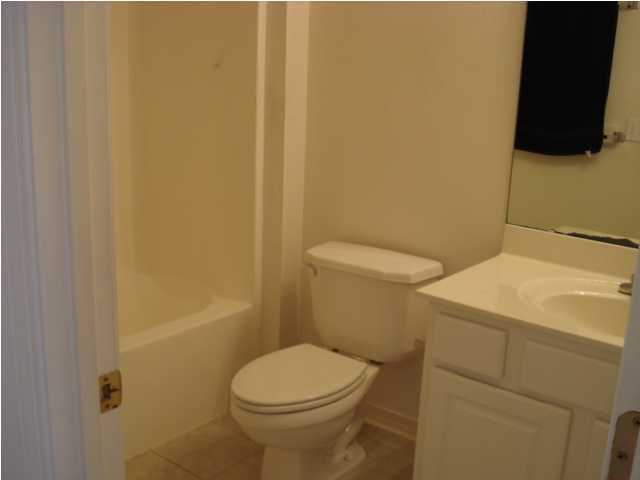 7 6th Shalimar, FL 32579 - Photo 11 of 23 a white toilet sitting next to a bath tub