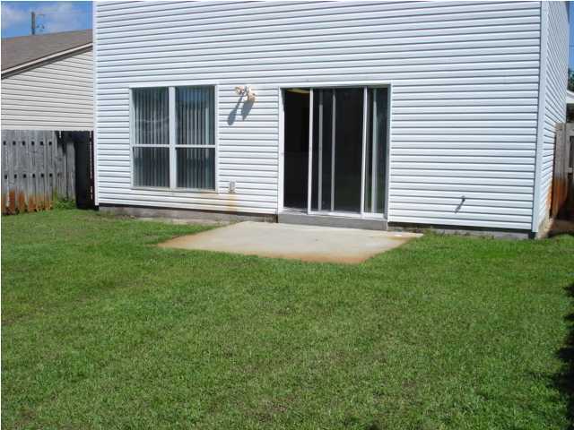 7 6th Shalimar, FL 32579 - Photo 12 of 23 a front view of a house with a yard and garage