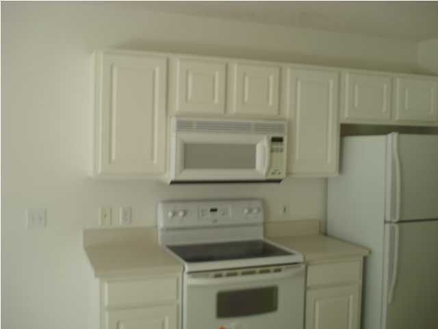 7 6th Shalimar, FL 32579 - Photo 21 of 23 a kitchen with white cabinets and white appliances