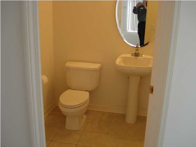 7 6th Shalimar, FL 32579 - Photo 7 of 23 a bathroom with a toilet and a mirror