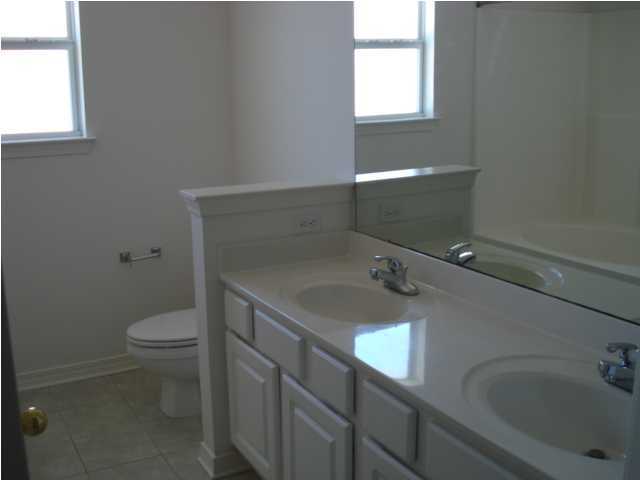 7 6th Shalimar, FL 32579 - Photo 9 of 23 a bathroom with a sink toilet and window