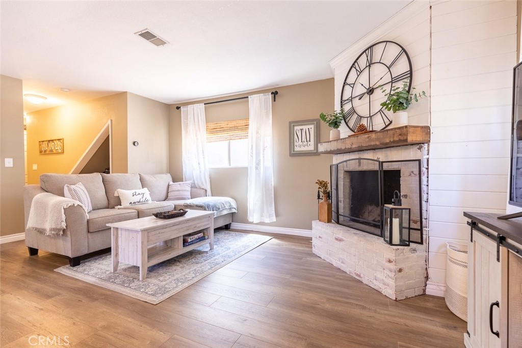 846 Maple Lane Sugarloaf, CA 92386 - Photo 4 of 13 a living room with furniture a fireplace and a flat screen tv
