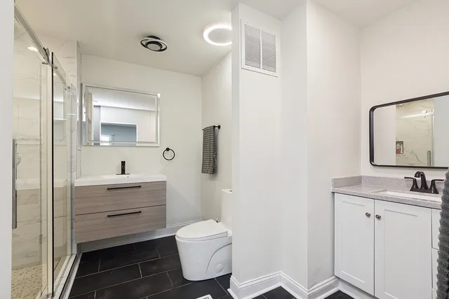 a bathroom with a toilet sink and mirror