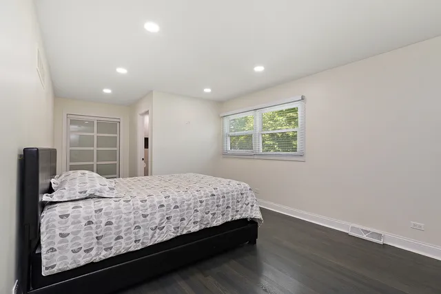 a bedroom with a large bed and a window