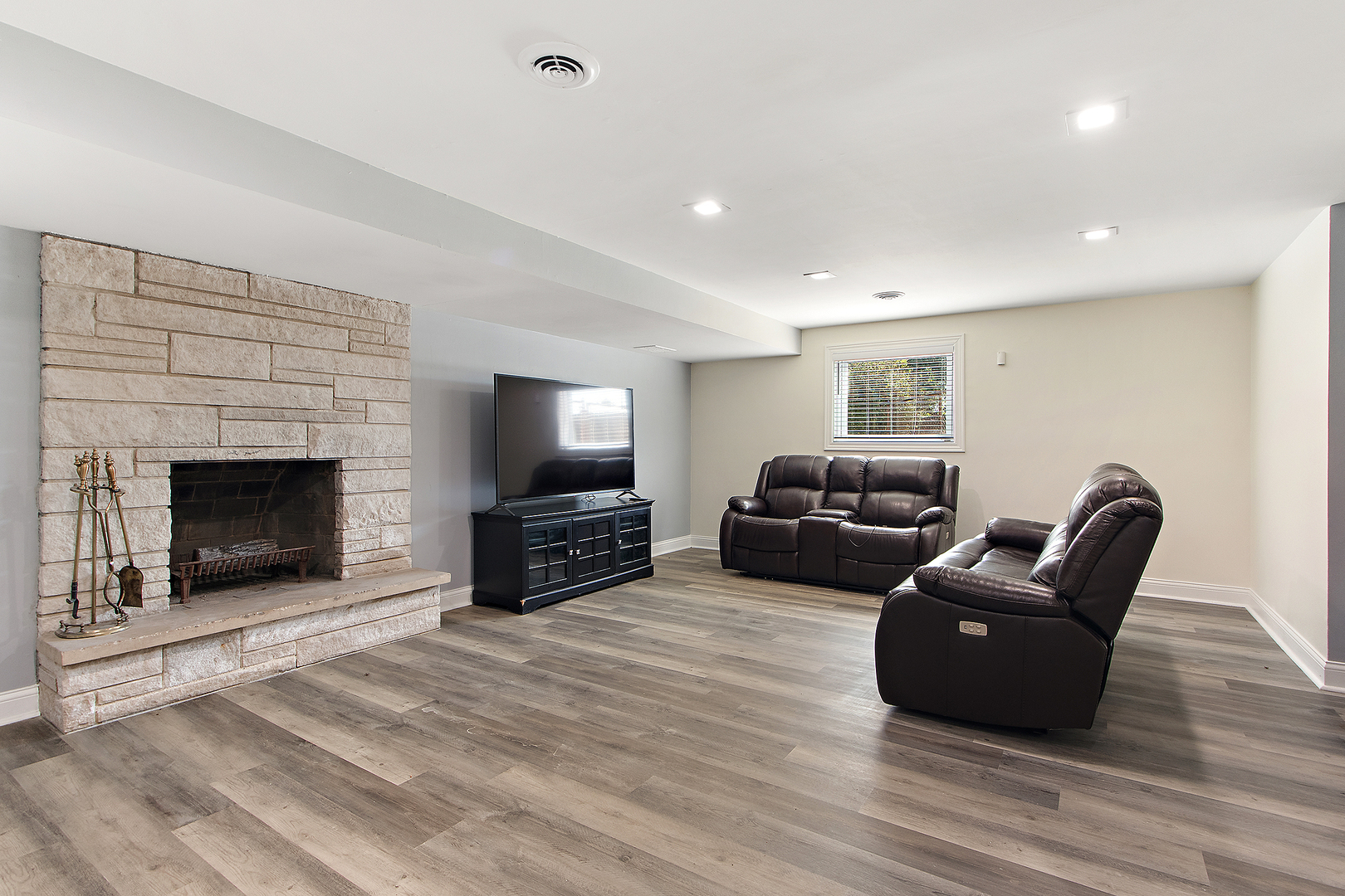 18849 Jamie Court Homewood, IL 60430 - Photo 26 of 35 a living room with furniture a flat screen tv and a fireplace