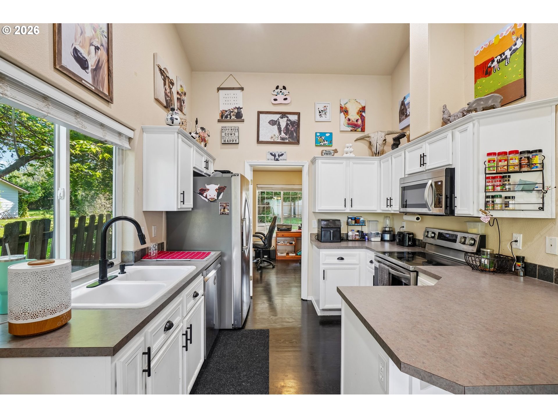 40348 Therese Street Sandy, OR 97055 - Photo 12 of 28 a kitchen with stainless steel appliances granite countertop a stove top oven a sink a dining table and chairs with the front door