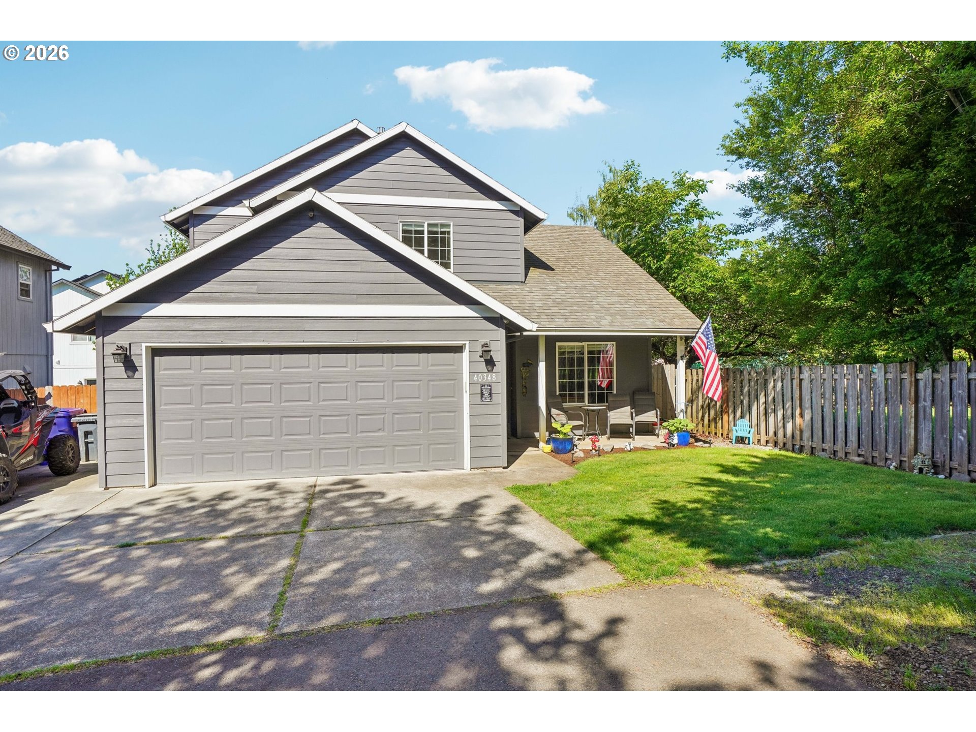 40348 Therese Street Sandy, OR 97055 - Photo 2 of 28 a front view of a house with a yard and garage
