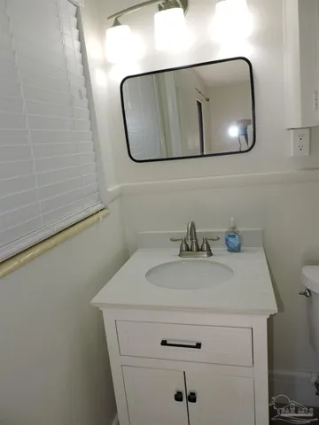a bathroom with a sink and mirror