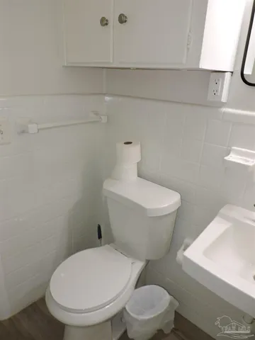 a white toilet sitting next to a bathroom sink
