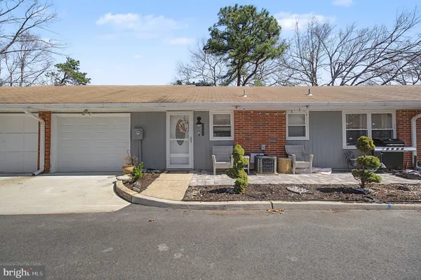 a front view of house with yard seating and garage