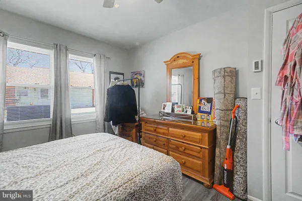 a bedroom with a bed dresser and a large mirror