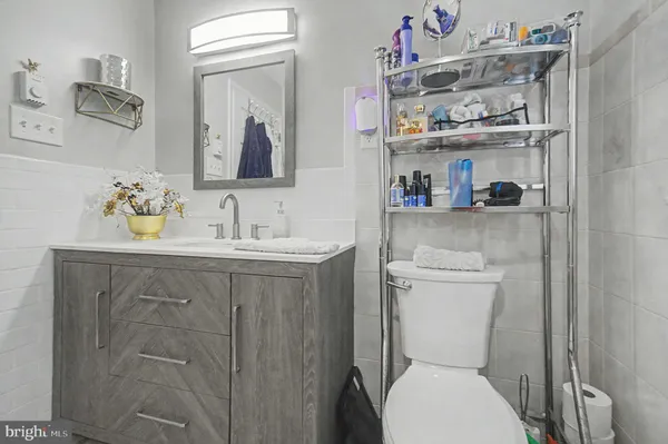 a bathroom with a sink a toilet and a mirror