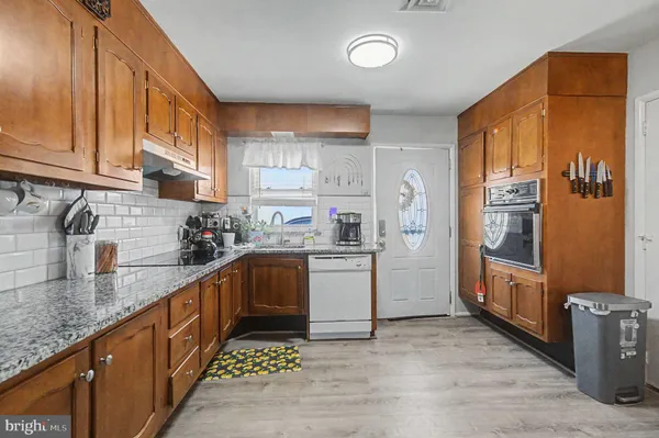 a kitchen with a sink stove and refrigerator