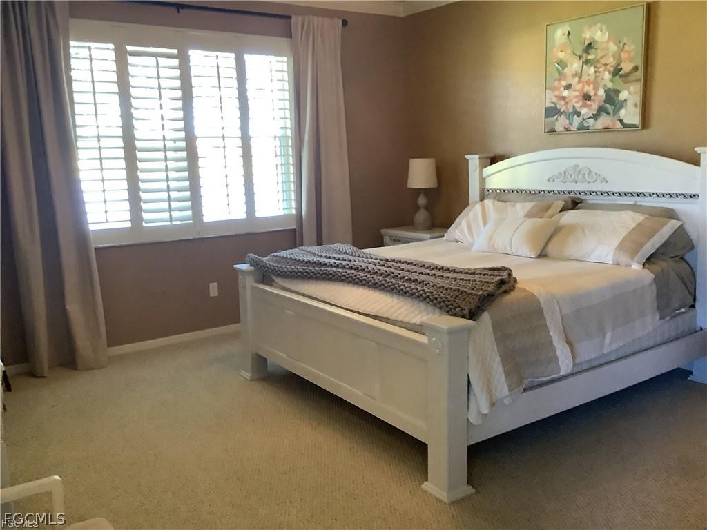 4791 Fairloop Run Lehigh Acres, FL 33973 - Photo 11 of 19 a bedroom with a bed and a window
