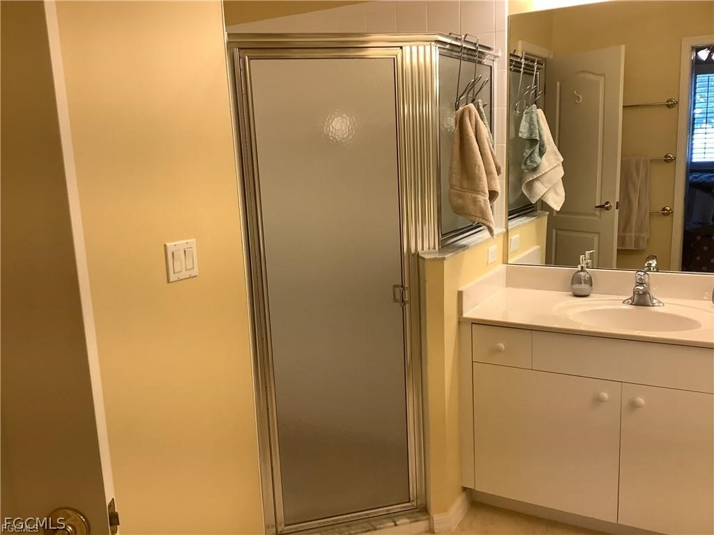4791 Fairloop Run Lehigh Acres, FL 33973 - Photo 13 of 19 a bathroom with a shower and a sink