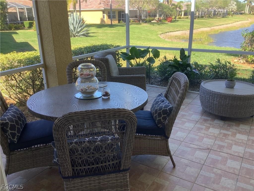 4791 Fairloop Run Lehigh Acres, FL 33973 - Photo 17 of 19 a view of a patio with a table chairs and a table