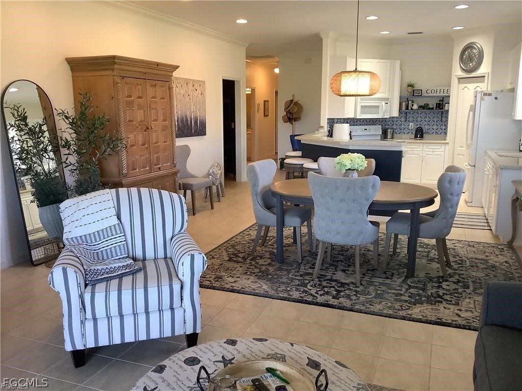 4791 Fairloop Run Lehigh Acres, FL 33973 - Photo 7 of 19 a view of a dining room with furniture