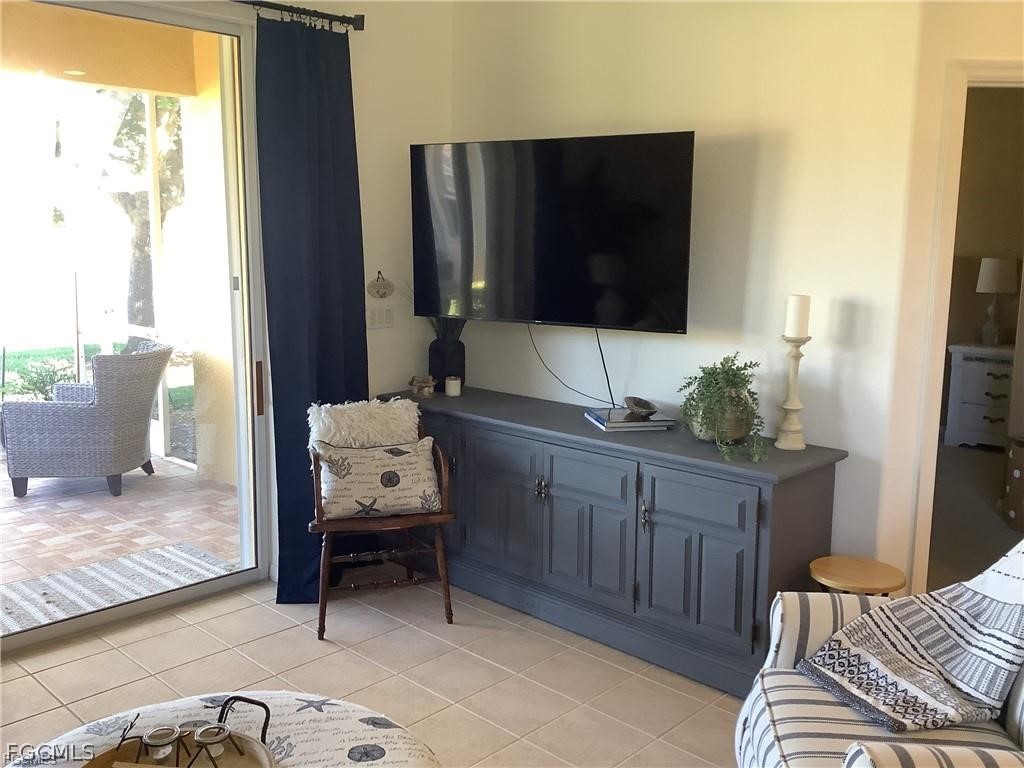 4791 Fairloop Run Lehigh Acres, FL 33973 - Photo 8 of 19 a living room with furniture and a flat screen tv